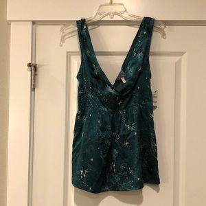 Celestial low cut top with elastic waist.